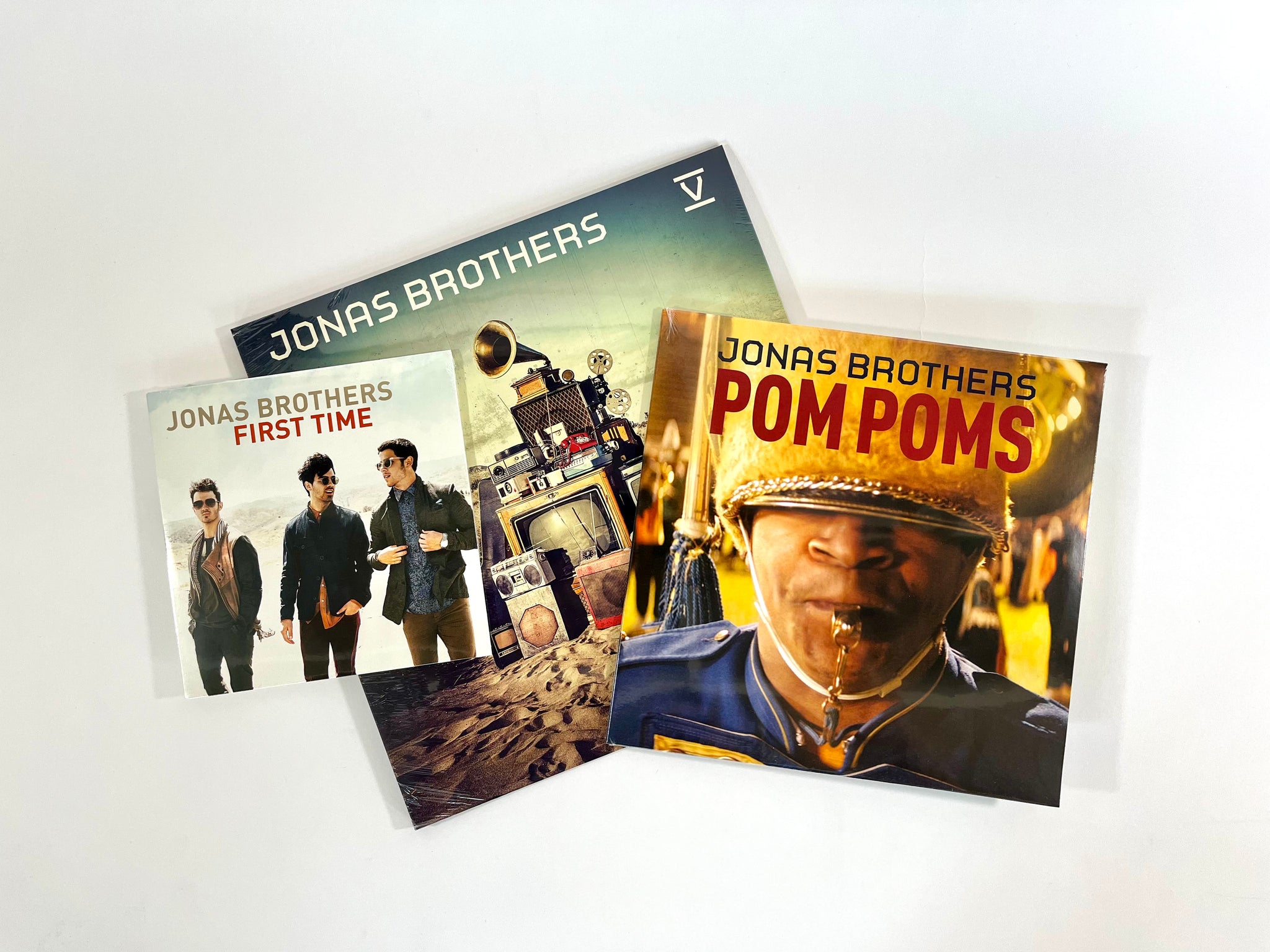 EXCLUSIVE "V" BUNDLE: Jonas Brothers "V" LP (clear vinyl) + Pom Poms (yellow & red splatter vinyl) 10 inch single! + First Time 7 inch single!